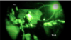 FILE - Screengrab of a video shot through night-vision lens shows U.S. servicemen conducting a mission in Iraq.