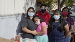 From left, Abigail Leocadio, stands with her children, Areli, 9, Eliel, 12, Zeret, 10, and Samai, 15, after a delivery from the Emmaus House food pantry. (AP Photo/Ross D. Franklin)