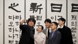 Bong Joon-ho, director of the four Oscar award-winning film 'Parasite', takes a selfie with cast members Song Kang-ho, Cho Yeo-jeong and Lee Sun-kyun at the Presidential Blue House in Seoul, South Korea, February 20, 2020.