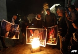 Palestinian protesters burn pictures of U.S. President Donald Trump at the manger square in Bethlehem, Dec. 5, 2017. Trump told Mideast leaders in phone calls that he would announce U.S. recognition of Jerusalem as Israel's capital. (AFP Photo)