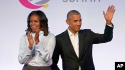 FILE - Former President Barack Obama, right, and former first lady Michelle Obama appear at the Obama Foundation Summit in Chicago, Oct. 31, 2017. 