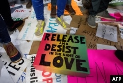 Signs are seen strewn about the ground as protesters rally at San Francisco International Airport in San Francisco, California, Jan. 29, 2017.