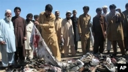 Pakistani villagers search for the belongings of their family members after a blast in Matani near Peshawar, Pakistan, March 9, 2011