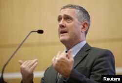 FILE - St. Louis Federal Reserve Bank President James Bullard speaks at a public lecture in Singapore, Oct. 8, 2018.