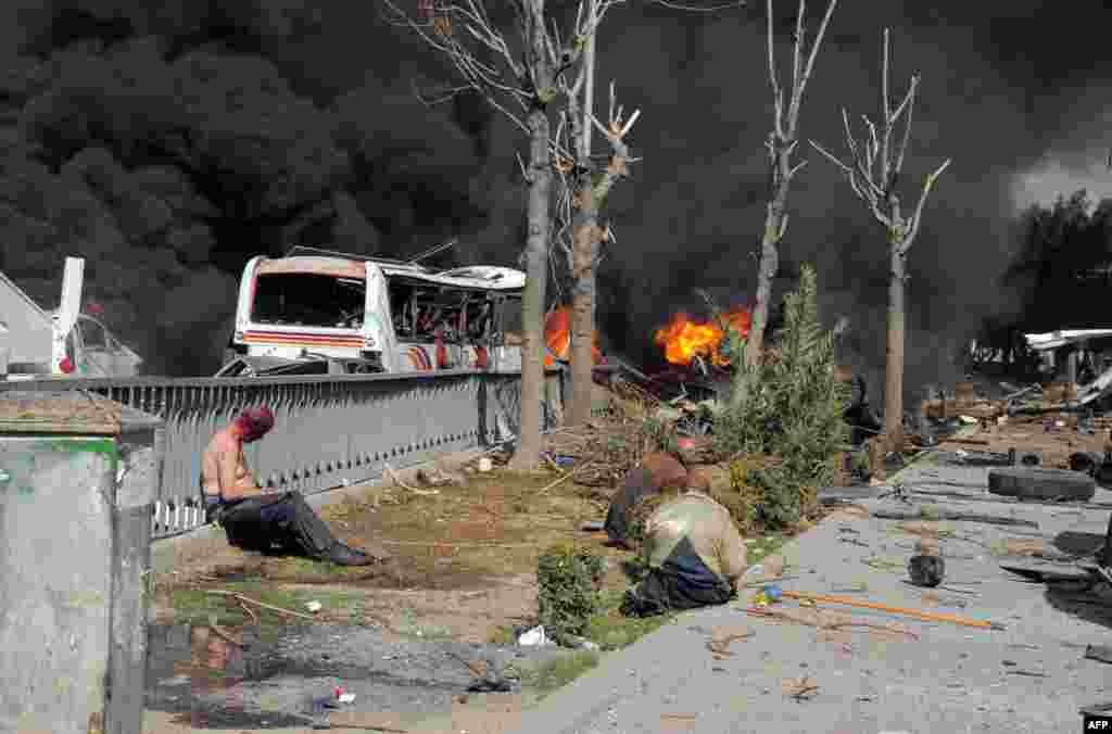 A handout picture released by the official Syrian Arab News Agency (SANA) on Feb. 21, 2013 shows wounded Syrians after a powerful car bomb exploded near the headquarters of Syria's ruling Baath party in the center of Damascus, police said.