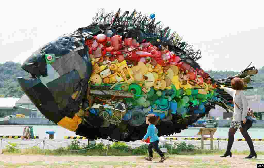 A large sea bream object, made from colorful debris found drifting at sea, such as plastic tanks, toys and wires, and created by Japanese art group Yodogawa Tecnique, is displayed at the Setouchi Triennale art event at the port of Uno, Okayama prefecture, Japan.