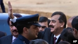 Pakistan's Prime Minister Yusuf Raza Gilani waves towards the media after arriving at the Supreme Court in Islamabad, January 19, 2012.