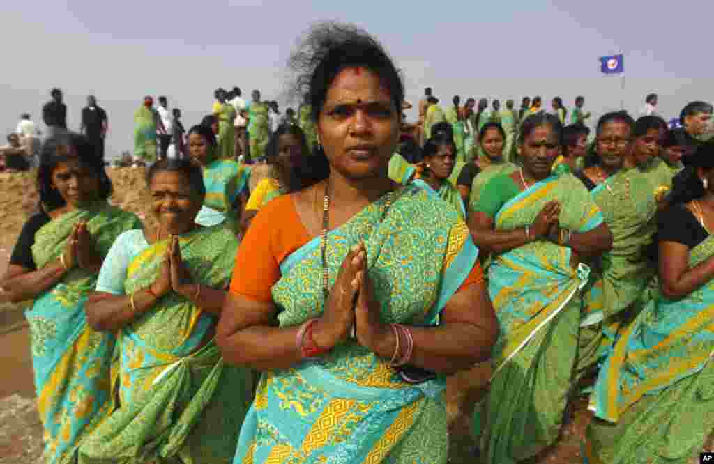 Indian women offer prayers on the Marina Beach at the Bay of Bengal to commemorate the 10th anniversary of the 2004 Tsunami in Chennai, India, Friday, Dec. 26, 2014.