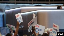 Delegates show their support for Hillary on the first night of the DNC (Photo: A. Shaker/VOA)