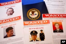 Press materials are displayed on a table of the Justice Department in Washington, May 19, 2014, before Attorney General Eric Holder was to speak at a news conference.