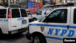 New York City Police Department (NYPD) vehicles patrol in Time Square after a man was arrested in an alleged plot to buy grenades for an attack on Times Square in New York, U.S., June 7, 2019.