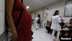 FILE - Pregnant woman waits for a routine general checkup, which includes Zika screening, at the maternity ward of the Hospital Escuela in Tegucigalpa, Honduras, Jan. 27, 2016. 