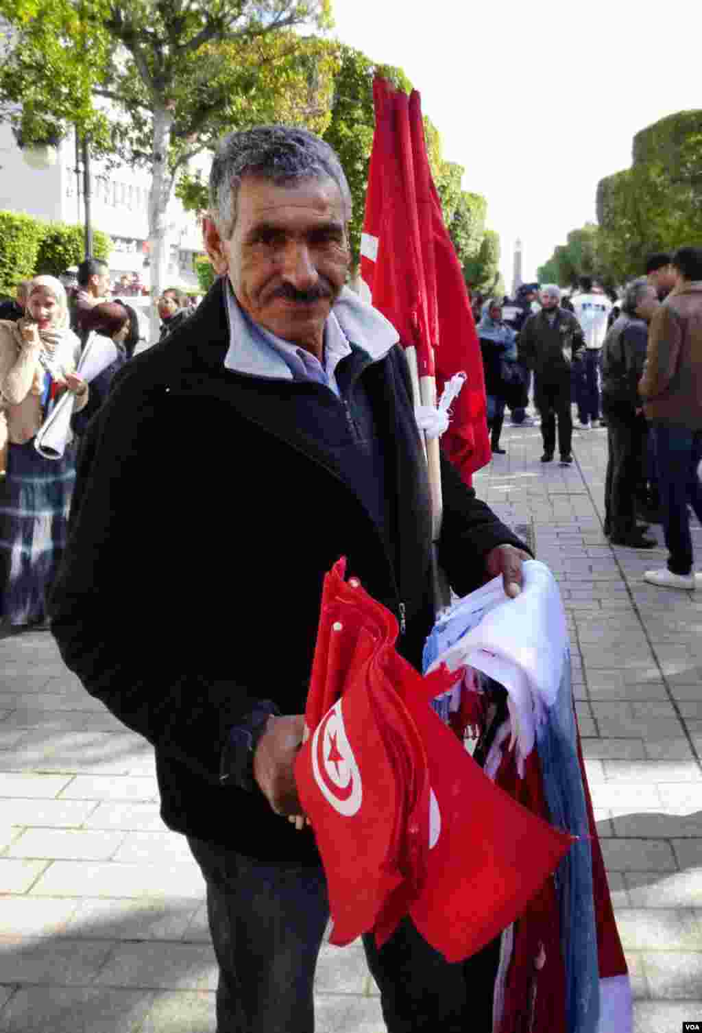 An Ennahda supporter selling flags in Tunis. (Henry Ridgewell for VOA)