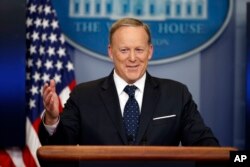 FILE - Then-White House press secretary Sean Spicer smiles as he answers a question during a briefing at the White House, in Washington, June 20, 2017.