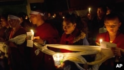 Tibetan exiles participate in a candlelit vigil in solidarity after reports of 52-year-old Tamdrin Dorjee's self-immolation in Tsoe Monastery in northwestern China's Gansu province, in Dharmsala, India, Saturday, Oct. 13, 2012.