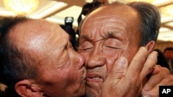 South Korean Yun Sang-in, left, kisses his North Korean elder brother Yun Tae Young on the last day of the three-day Separated Family Reunion Meetings at Diamond Mountain in North Korea, Nov. 1, 2010. 
