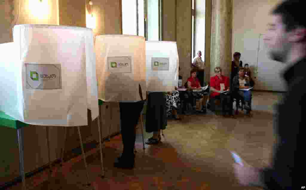 Georgians vote during Parliamentary elections at a polling station in Tbilisi, October 1, 2012. Voters in Georgia are choosing a new parliament in a heated election that will decide the future of Saakashvili's government.