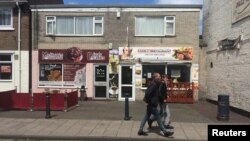 Men walk past a Polish restaurant in Boston, Britain, June 27, 2016. 