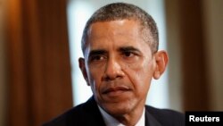 U.S. President Barack Obama looks up during a meeting with Baltic leaders at the White House, Aug. 30, 2013. During the meeting the president spoke with reporters about the crisis in Syria. 