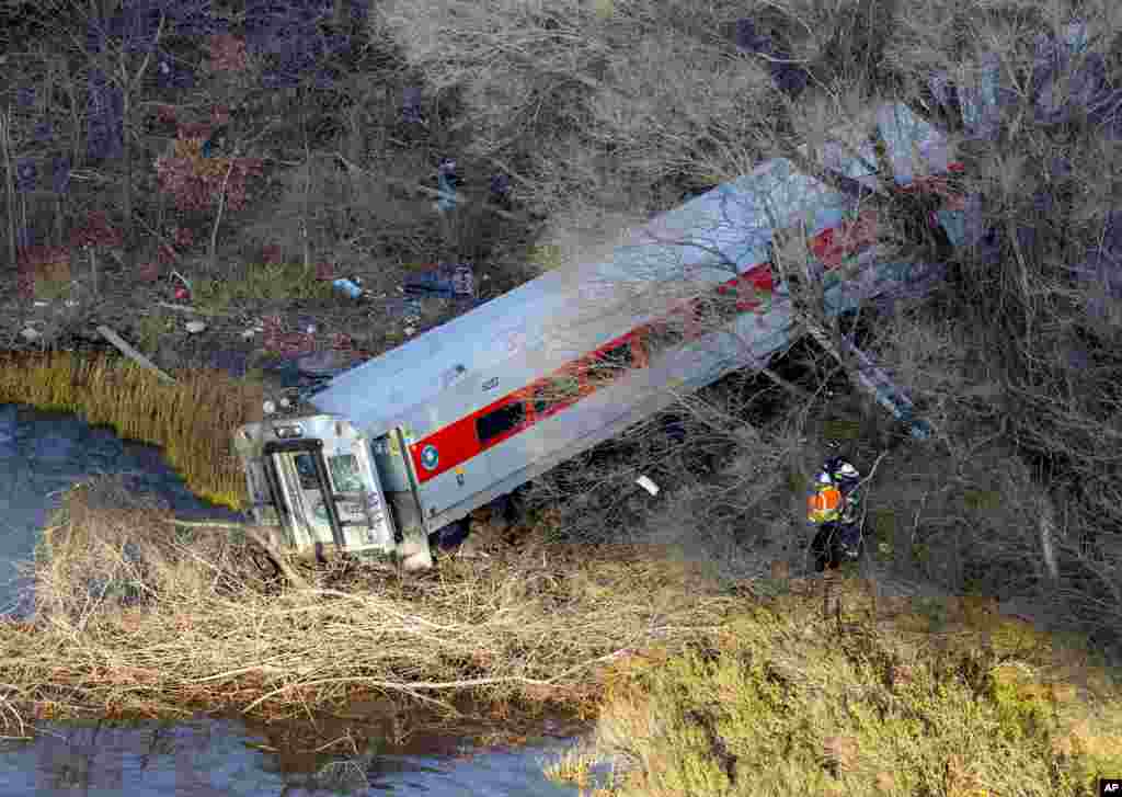 Tim SAR mengunjungi kereta penumpang Metro-North yang tergelincir di Bronx, New York, 1 Des., 2013. Dinas Pemadam Kebakaran New York menyatakan ada 130 petugas di tempat kejadian. 