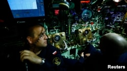 Polish marines of submarine ORP SEP watch instruments as the submarine dives during NATO Submarine Rescue Exercise Dynamic Monarch on Gdansk Bay, near Hel in the Baltic Sea, May 22, 2014. 