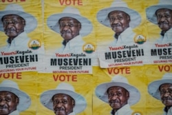 Posters of Uganda's President Yoweri Museveni who is running for his 6th presidential term are seen on a wall in Kampala, Uganda, on Jan. 4, 2021.