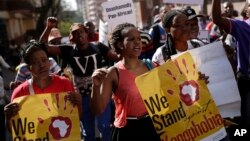 FILE - People rally during a march against xenophobia, in downtown Johannesburg, South Africa, 2015. Anti-foreigner sentiments have been on the rise in the country which, according to most recent data, is home to some two million foreign nationals. (AP Photo/Jerome Delay)