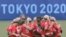 Canada's softball players gather after losing the game during the Tokyo 2020 Olympic Games softball opening round game between USA and Canada at Fukushima Azuma Baseball Stadium in Fukushima, Japan, on July 22, 2021. 