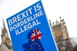 An anti-Brexit placard is held in Parliament Square, in London, Dec. 16, 2020.