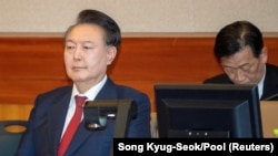 South Korea's impeached President Yoon Suk Yeol attends a hearing at his impeachment trial over his short-lived imposition of martial law, at the Constitutional Court in Seoul, Feb. 20, 2025. 