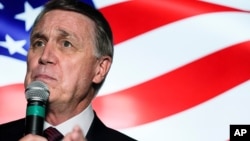 FILE - In this Nov. 13, 2020, photo, Sen. David Perdue speaks during a campaign rally, in Cumming, Ga.