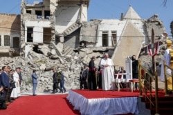 Pope Francis, surrounded by shells of destroyed churches, arrives to pray for the victims of war at Hosh al-Bieaa Church Square, in Mosul, Iraq, once the de-facto capital of IS, March 7, 2021.