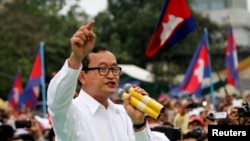 FILE - Sam Rainsy (C), leader of the opposition Cambodia National Rescue Party is seen speaking at a protest in central Phnom Penh.