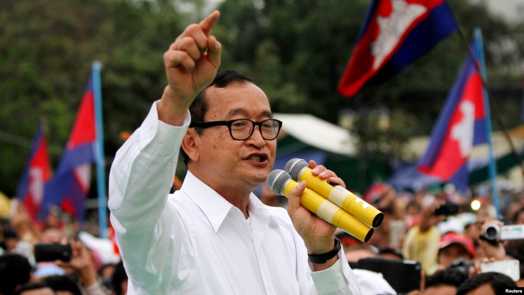 FILE - Sam Rainsy, shown at a Phnom Penh rally in 2013, says his Cambodian National Rescue Party would support Hang Puthea as the ninth, neutral member of the National Election Committee.