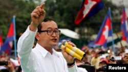 FILE - Sam Rainsy (C), leader of the opposition Cambodia National Rescue Party is seen speaking at a protest in central Phnom Penh.