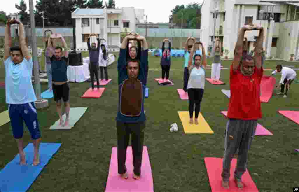 Afghans and foreigners attend yoga classes a day ahead of International Yoga Day, at the Indian Embassy in Kabul, Afghanistan, Saturday, June 20, 2015. (AP Photo/Massoud Hossaini)