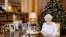 Britain's Queen Elizabeth sits at a desk in the 1844 Room after recording her Christmas Day broadcast to the Commonwealth, in Buckingham Palace, in this undated photograph received in London, Dec. 24, 2017. 