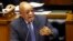 FILE - South African President Jacob Zuma answers questions in parliament in Cape Town, South Africa, March 17, 2016. Zuma has been ordered to pay $500,000 to reimburse the treasury for using public funds to pay for upgrades at his home.