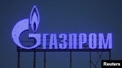 FILE - The logo of Gazprom company is seen on the facade of a business center in St. Petersburg, Russia. 