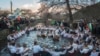 Bulgarians sing, play bagpipes and chain dance in the icy waters of the Tundzha river during Epiphany, in Kalofer.