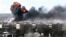 This video image taken from amateur video and broadcast by Bambuser/Homslive shows a series of devastating explosions in the central Syrian city of Homs, Syria, June 11, 2012.