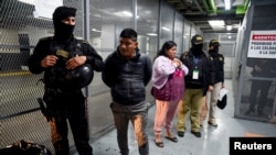 Migrant smugglers Josefa Quino Canil and Macario Chitic are seen after being detained in for their involvement in a deadly 2021 truck accident that killed 56 migrants in southern Mexico, following a court hearing in Guatemala City, Guatemala, December 9, 2024. 