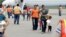 A handout provided by the Honduran Presidential House shows women and children walking on the tarmac after being deported from the U.S., at the Ramon Villeda international airport in San Pedro Sula, July 14, 2014.