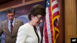 FILE - Republican Sen. Susan Collins, right, and Democratic Sen. Martin Heinrich leave a news conference on Capitol Hill in Washington, June 21, 2016.