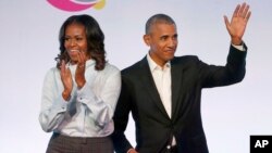 FILE - Former President Barack Obama, right, and former first lady Michelle Obama appear at the Obama Foundation Summit in Chicago, Oct. 31, 2017. 