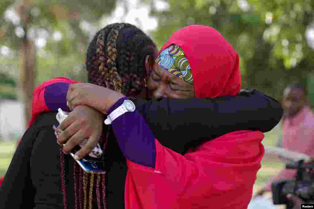 Members of the #BringBackOurGirls (#BBOG) campaign embrace each other in Abuja, Nigeria. A teenager kidnapped by Boko Haram more than two years ago has been rescued, the first of more than 200 girls seized in a raid on their school in Chibok town to return from captivity in the insurgents&#39; forest lair, officials said.