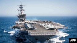 FILE - This U.S. Navy handout photo shows the aircraft carrier USS Theodore Roosevelt as it transits the Pacific Ocean while conducting a tailored ship’s training availability off the coast of Southern California on April 30, 2017.