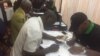 Some of the officials registering President Robert Mugabe and his wife, Grace, in Harare.