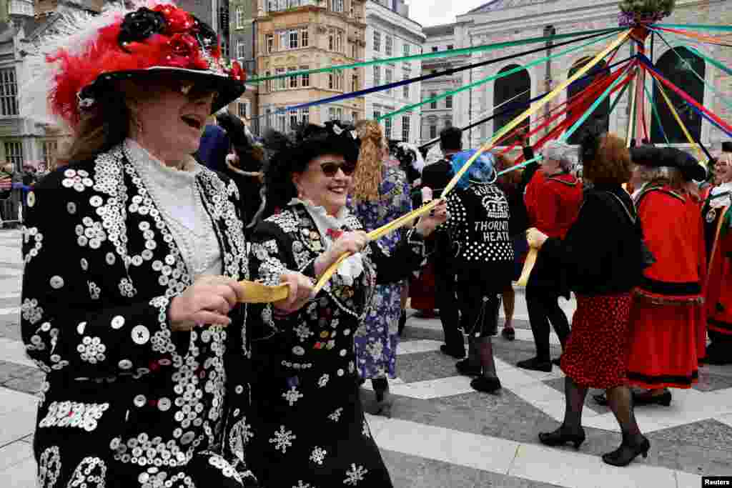 Pearly Kings and Queens dance around the maypole during the annual harvest festival at the Guildhall in London.