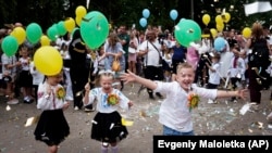 First-graders attend the traditional ceremony for the first day of school in Zaporizhzhia, Ukraine, Sunday Sept. 1, 2024. (AP Photo/Evgeniy Maloletka)
